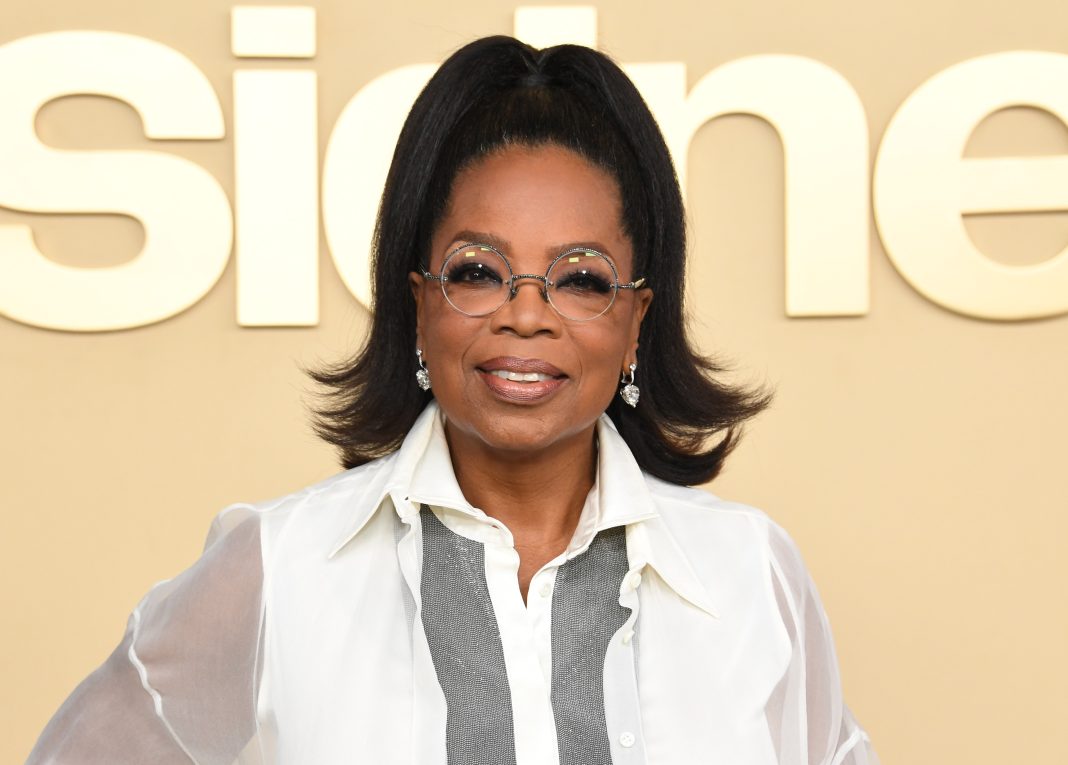 i-could-probably-see-my-reflection-in-oprah’s-glossy,-high-half-ponytail